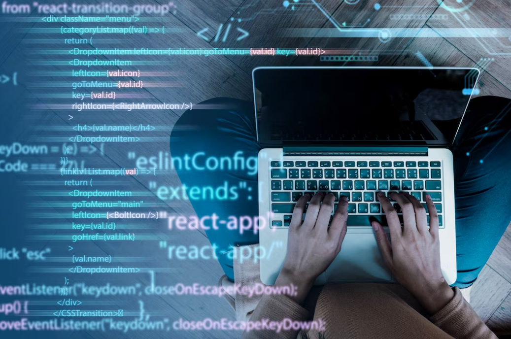 man sitting on the wooden floor typing on the laptop keyboard, and coding on the picture