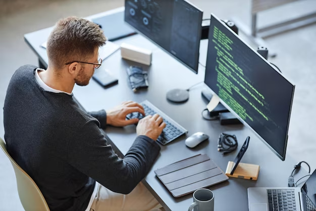 High angle view of a programmer working on code